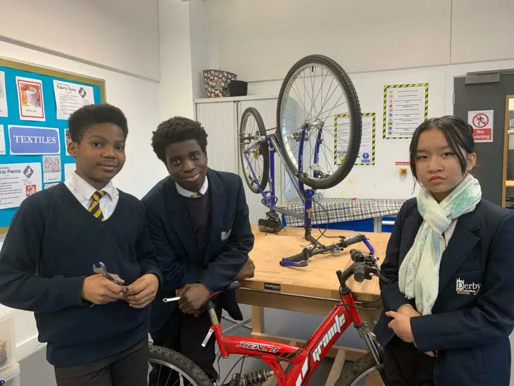 Victor Okoro, Mark Alade and Joleen Ballesteros have been learning how to repair bikes