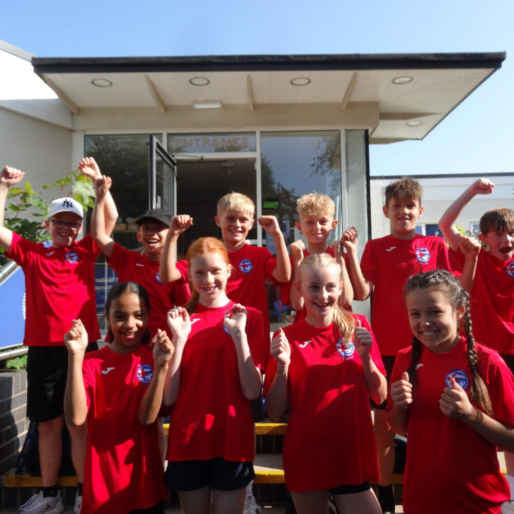 Students from Walter Evans Primary School celebrating their School Games Platinum Mark award win